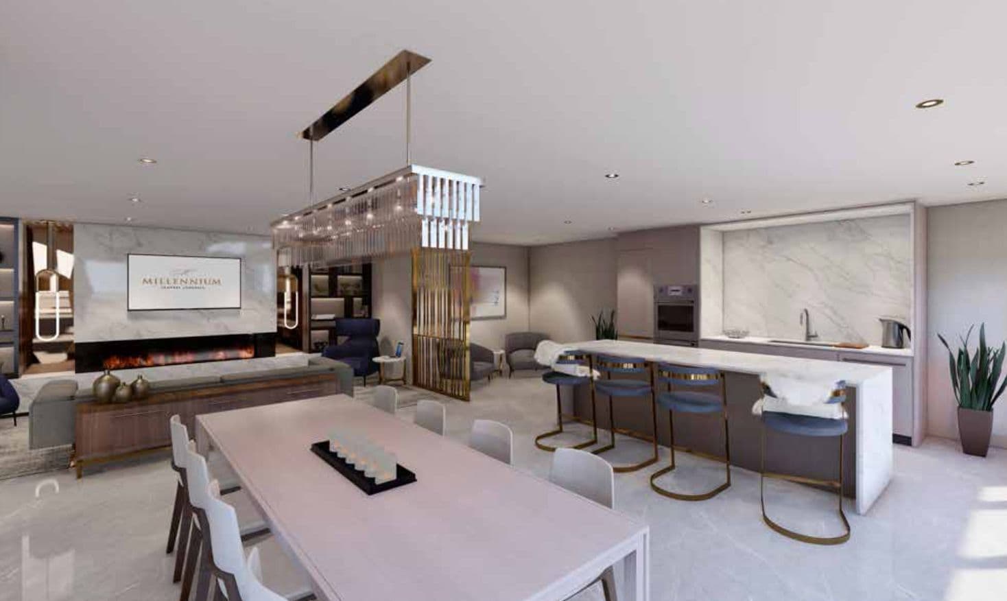 Millennium Central Lonsdale Condos – A resident lounge with a fireplace, a screen reading 'Millennium', a communal dining table, and a marble-backsplash kitchenette.