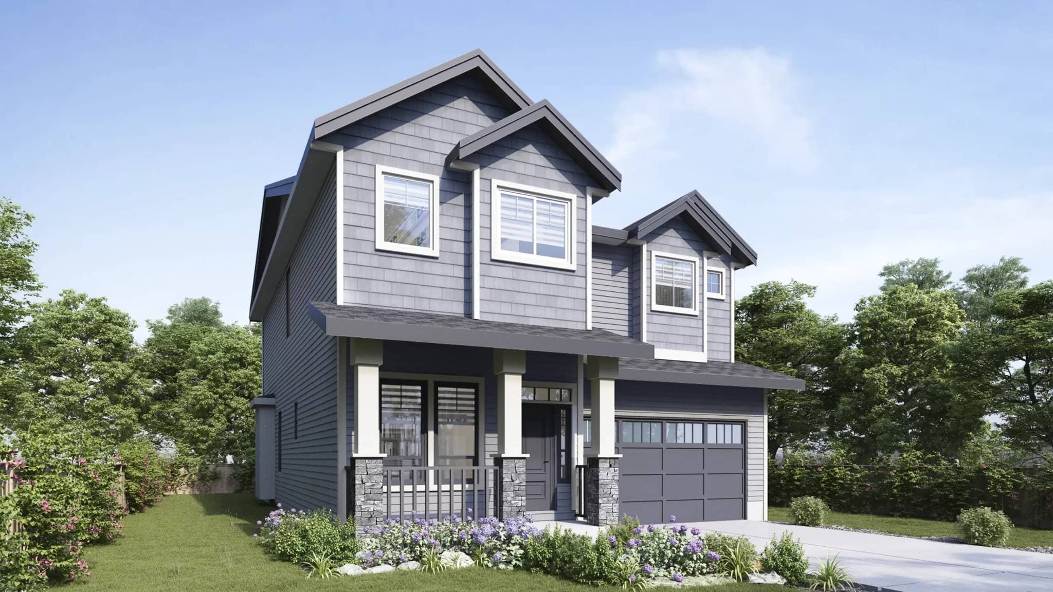 Bloom at Yorkson – A two-story single-family home featuring cool gray horizontal siding and shake shingles, a front porch with stone-base pillars, and an attached one-car garage. Landscaping includes green lawn, purple flowering shrubs, and surrounding lush green trees under a bright blue sky.