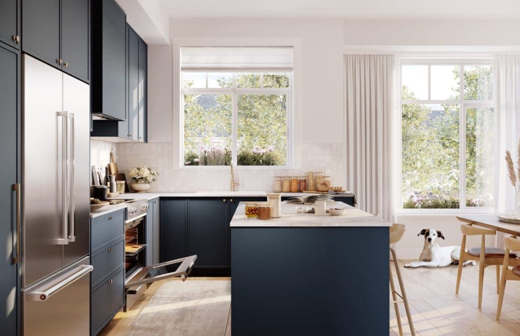 Riley Park – Dark blue kitchen with stainless fridge, open oven drawer, an island, and a dog lying on the floor near a dining area with large windows.