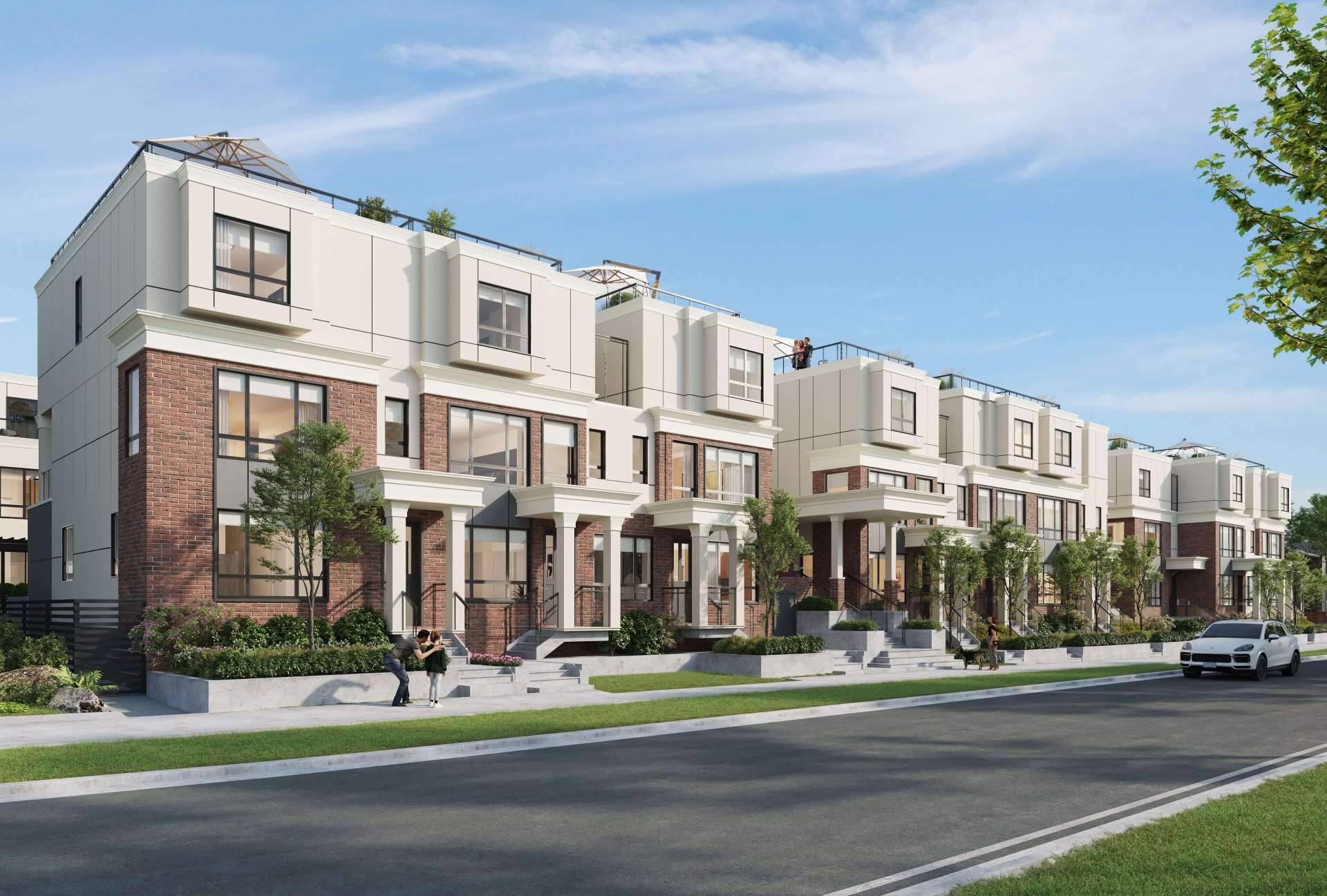 Astrid – A street-level rendering of a row of modern multi-story townhomes featuring red brick bases, off-white upper facades, large windows, covered front entry porches, and private rooftop patios. The sunny daytime scene includes landscaped front gardens, a paved street with a white car parked along the curb, and people strolling on the sidewalk.