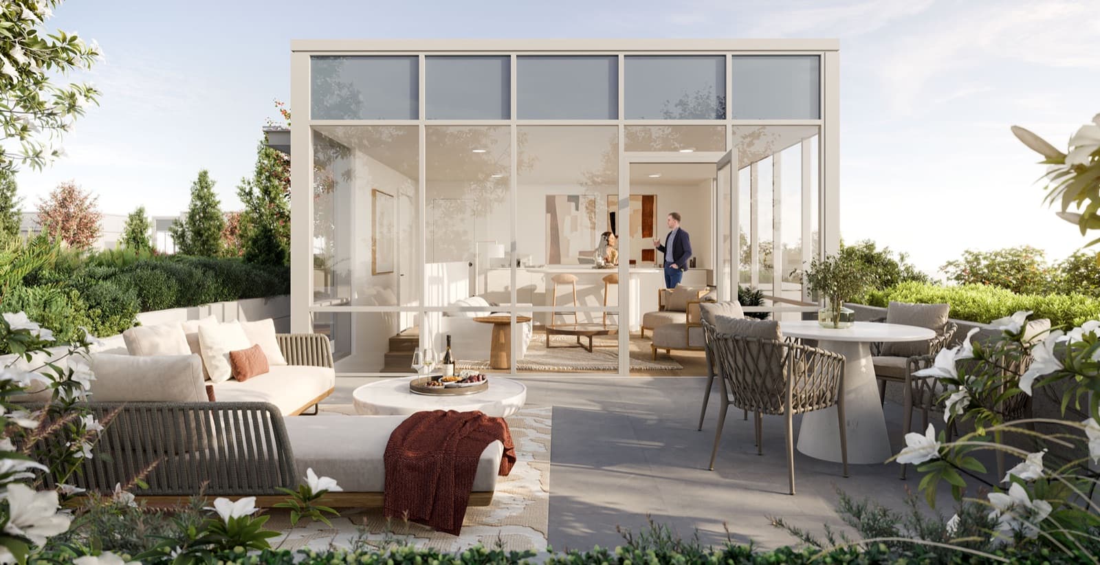 Chapter – Rooftop terrace lounge with a glass-walled pavilion, outdoor sofas and dining table, and people relaxing and chatting.