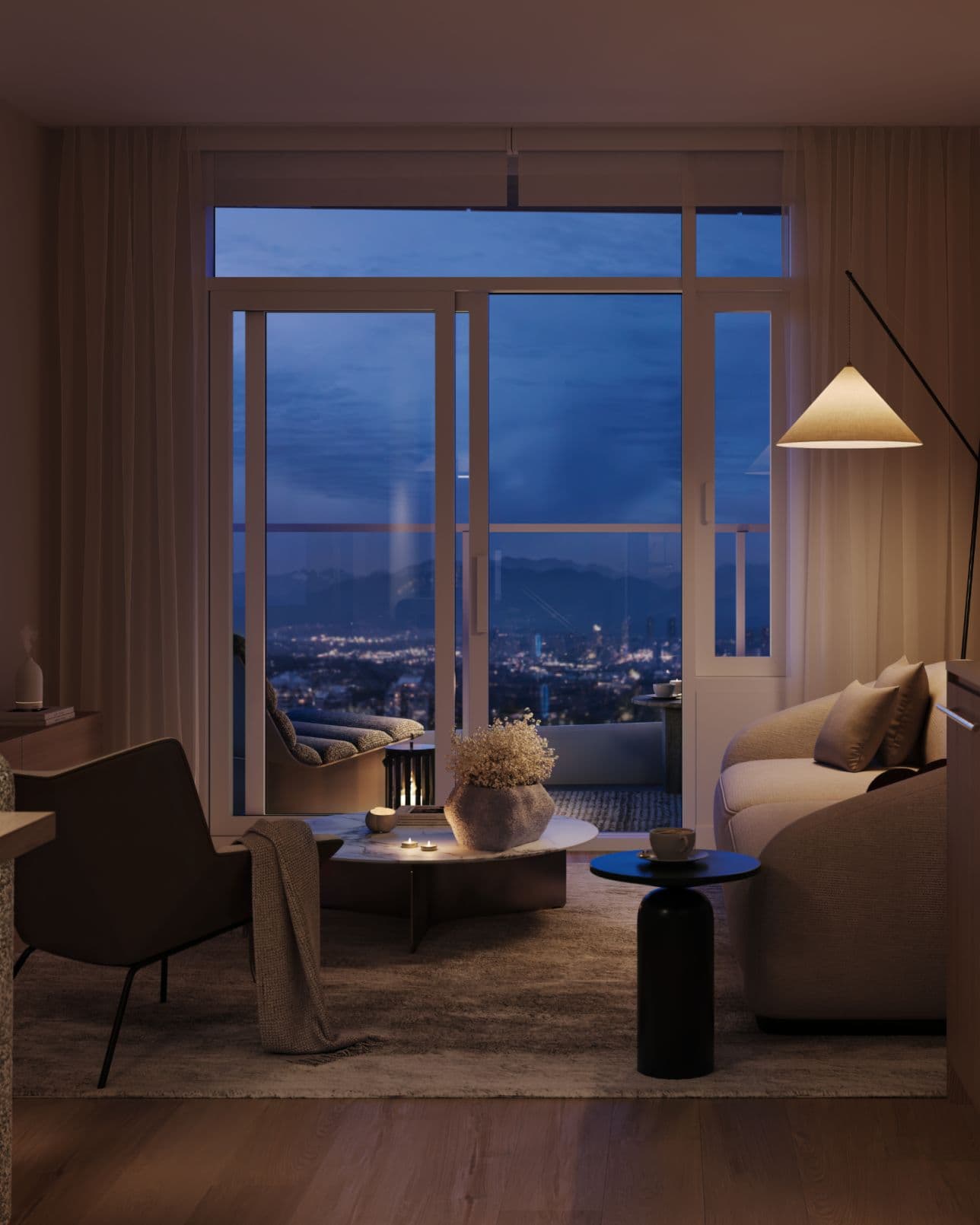 Ethos – A cozy, dimly lit living room set at dusk, featuring a plush sofa, an accent chair with a throw blanket, and floor-to-ceiling glass patio doors. Beyond the balcony, a sprawling city skyline and distant mountain silhouette glow beneath a twilight blue sky.