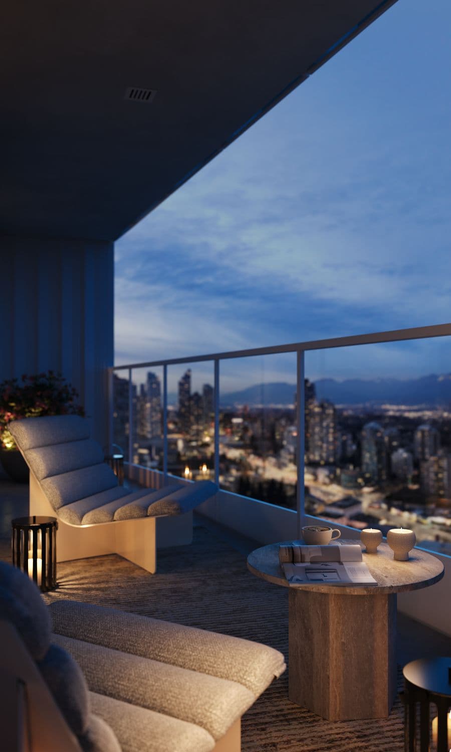 Ethos – A modern private balcony set up with cushioned lounge chairs, a small stone coffee table, and warm lantern lighting at dusk. Beyond the glass railing lies an expansive view of a glowing city skyline and distant mountain silhouettes under a deep blue evening sky.
