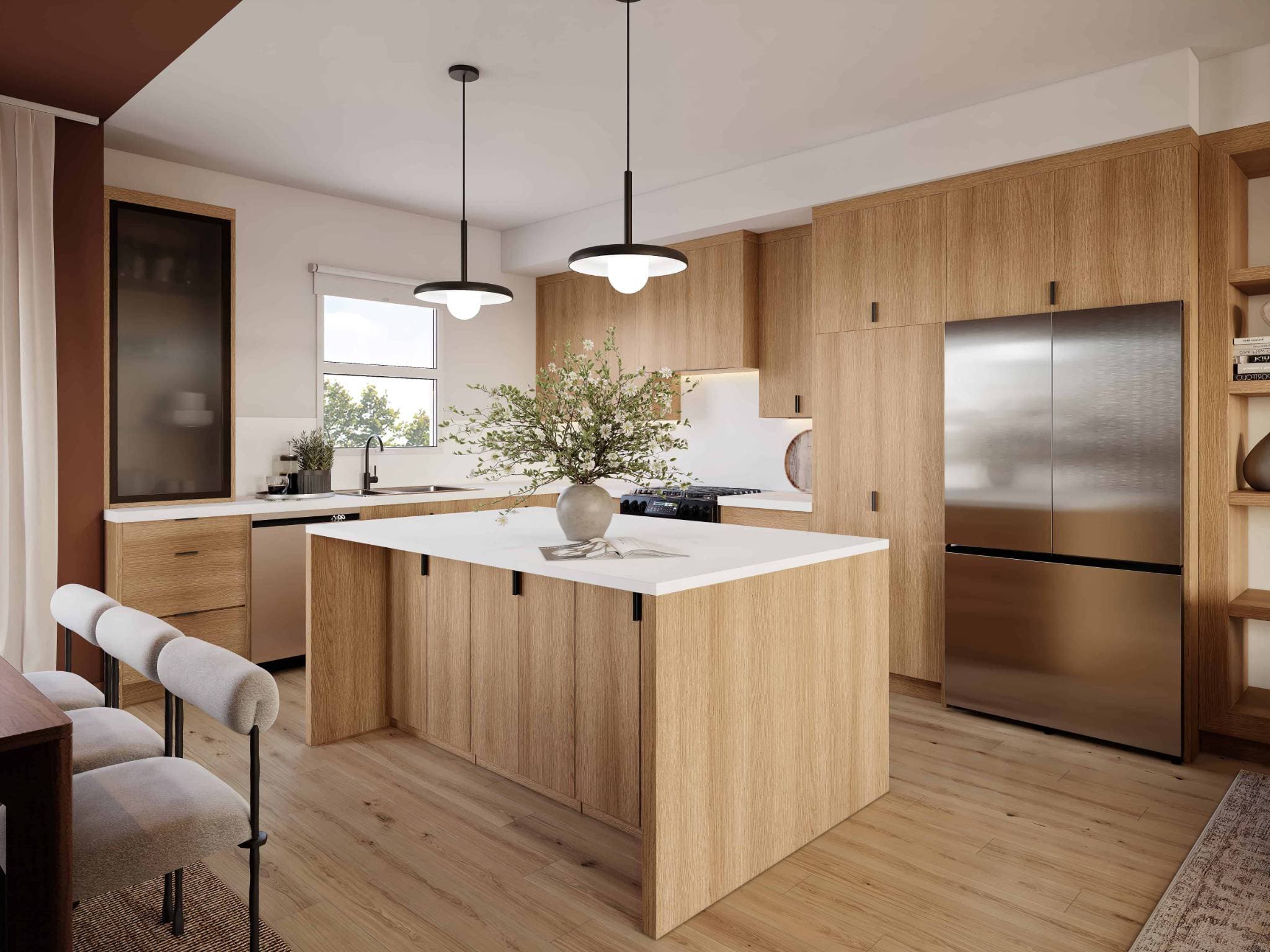 Eden Townhomes – A modern kitchen with light wood cabinetry, a large island with white countertop, pendant lighting, and a stainless steel french-door refrigerator.