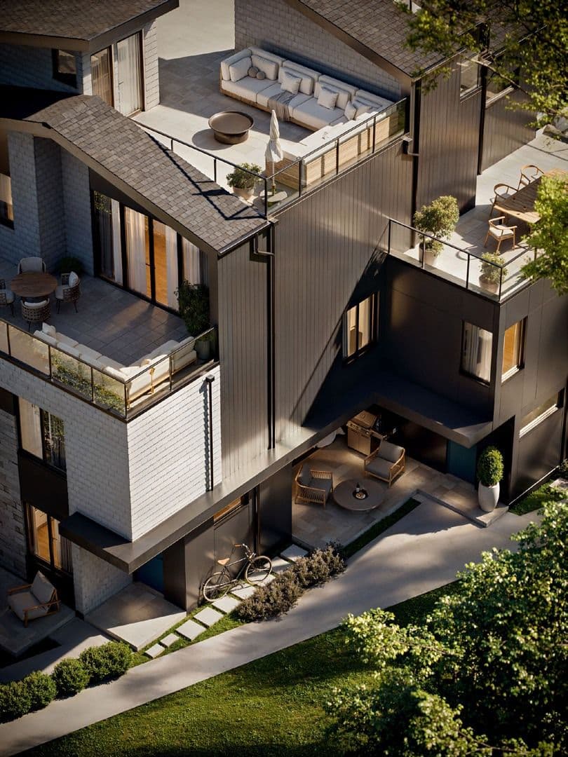 Katsura – An elevated exterior view of a contemporary multi-level townhome featuring dark vertical siding, light brick accents, and multiple tiered outdoor terraces furnished with lounge seating and dining areas. A paved walkway and landscaped ground-level patio with an outdoor seating nook and a parked bicycle complete the sunlit scene.