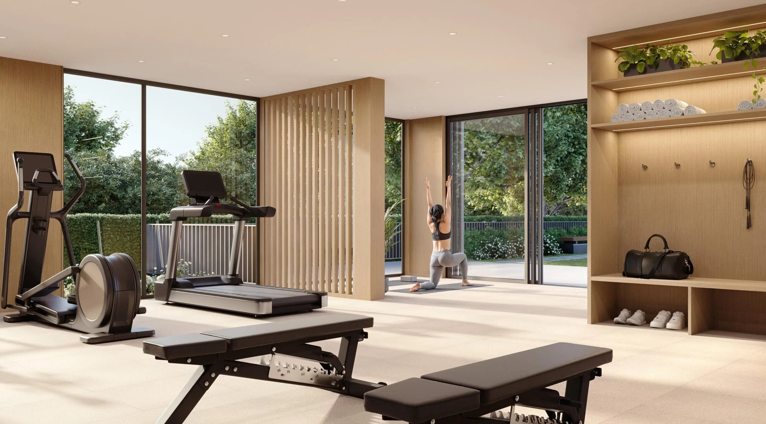 Rhodes – Bright fitness centre with treadmill, elliptical and weight benches, a yoga area in use, and floor-to-ceiling glass opening onto a landscaped courtyard.