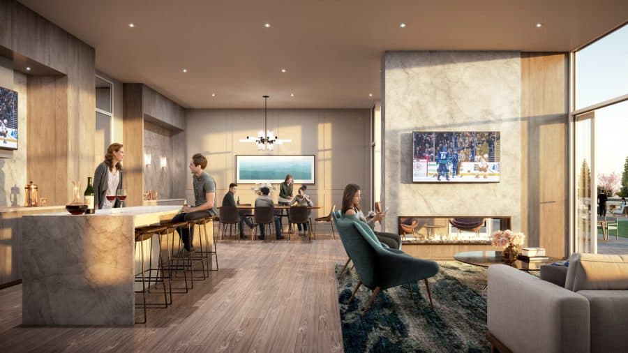 The Heights on Austin – Shared indoor lounge with a marble bar and stools, a communal dining table, lounge seating, and a fireplace with a mounted TV.