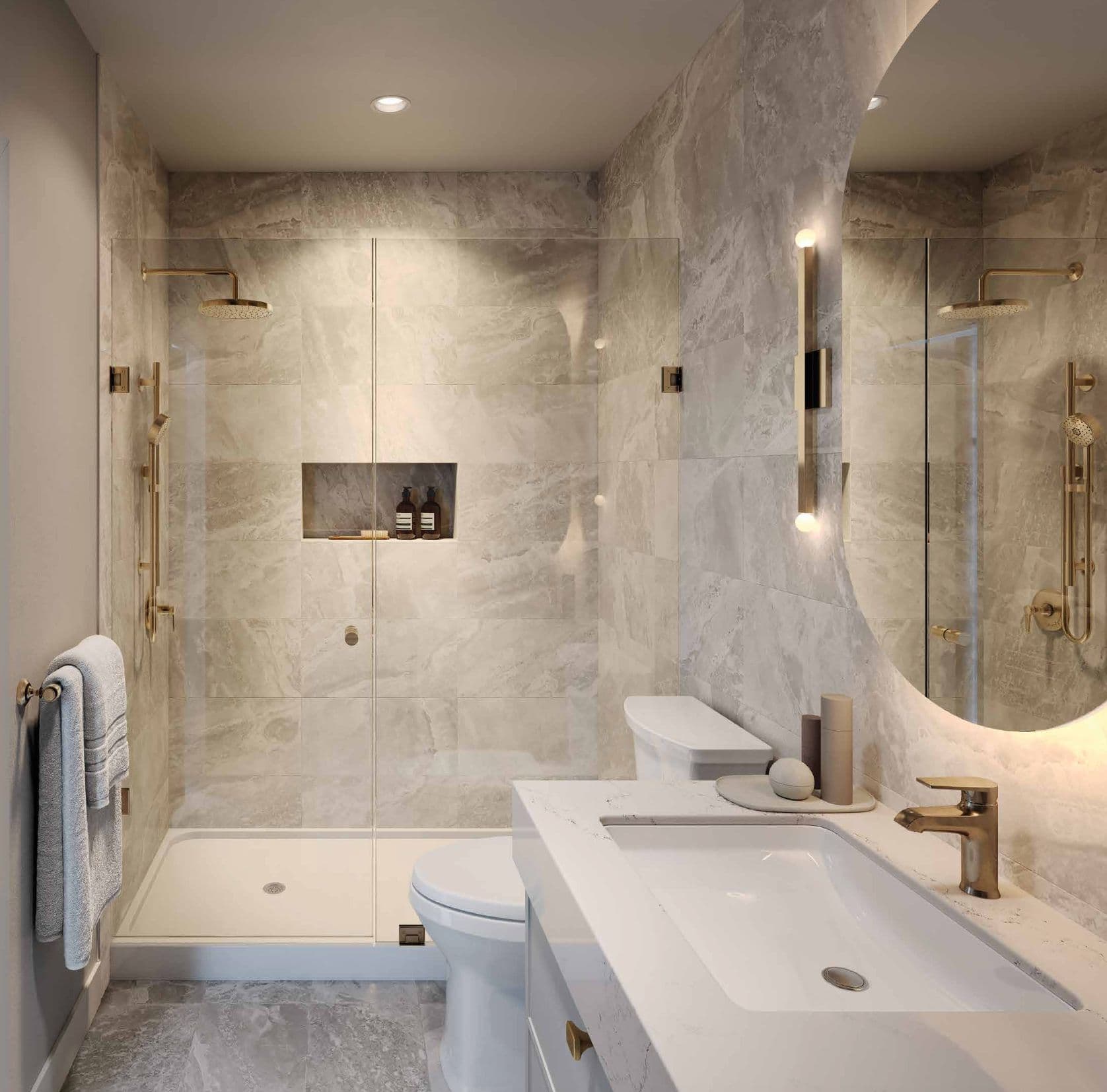 Reign Metrotown – Bathroom with a large walk-in glass shower, marble-look tile, gold fixtures, and a round backlit mirror.