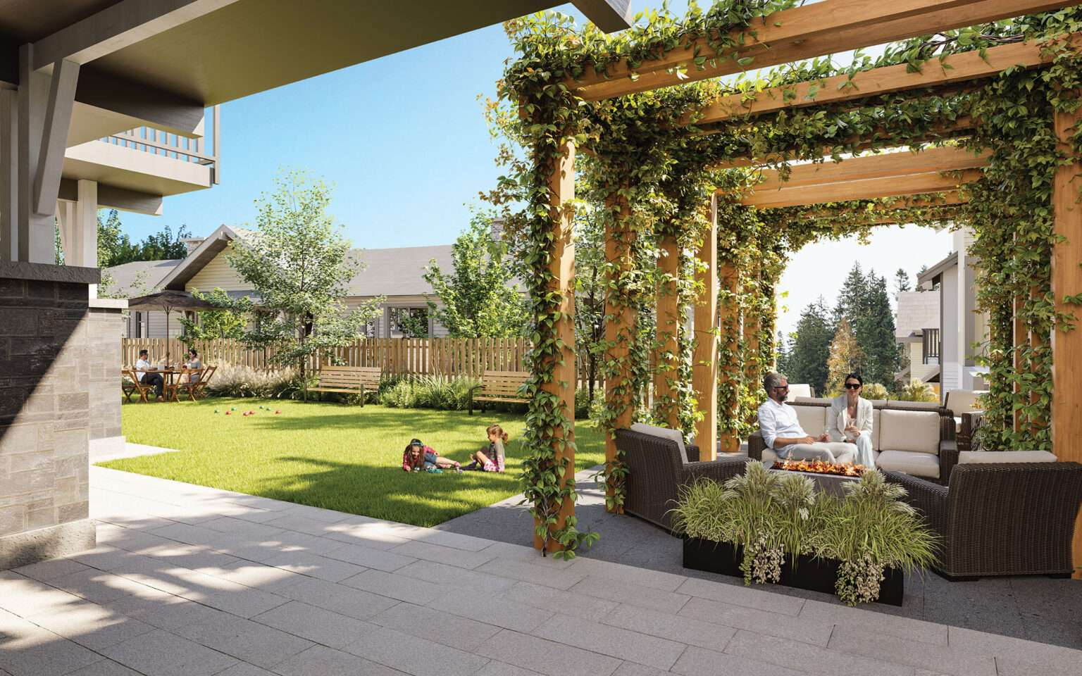 Terrayne Towns – A sunny outdoor courtyard featuring a vine-covered wooden pergola with plush outdoor lounge seating surrounding a central fire table. Adjacent to the patio is a manicured green lawn with wooden benches, surrounded by residential buildings under a bright, clear blue sky.