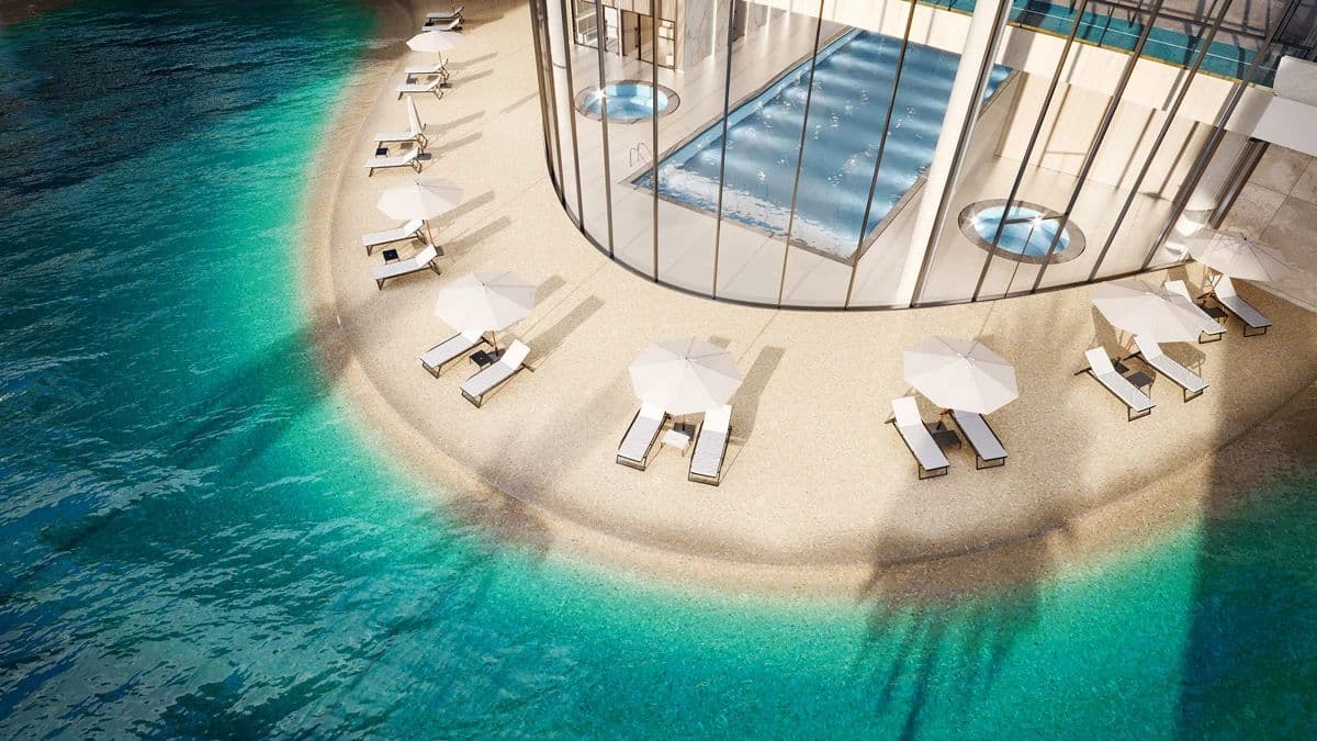 Circle at Concord Brentwood – Rendering of a rooftop pool deck seen from above, with a curved beach-style sand edge, lounge chairs, and umbrellas surrounded by water.