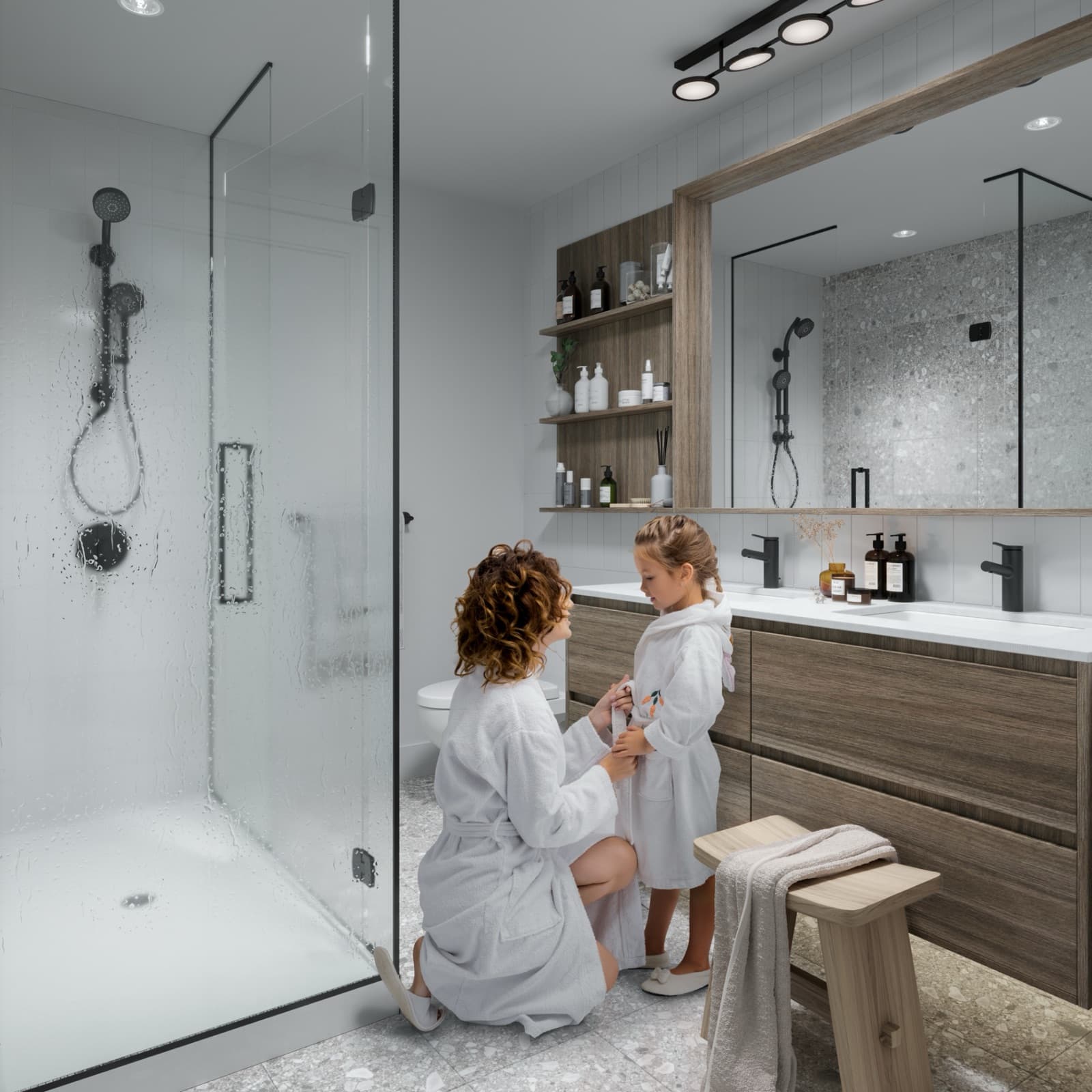 Umbra at Portwood – A modern bathroom with a walk-in glass shower, double sink wooden vanity, terrazzo tiled floor, and warm wood accents.