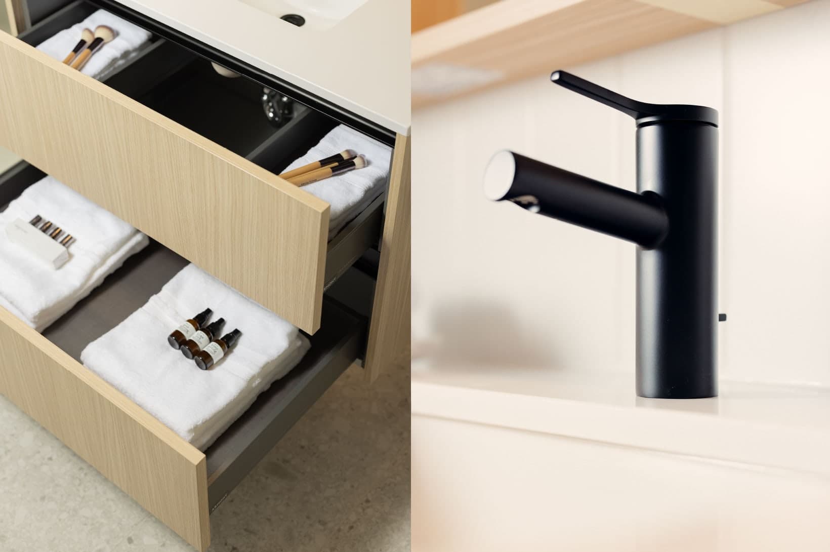 Umbra at Portwood – Close-up of open vanity drawers showing organized storage for towels and bathroom essentials, next to a black faucet.
