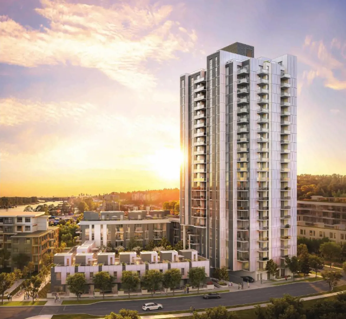 Paradigm – An elevated view showcases a modern high-rise residential tower flanked by lower-rise townhomes along a tree-lined street during a bright sunset. In the background, a scenic river and distant city skyline are illuminated by the warm, golden glow of the setting sun.