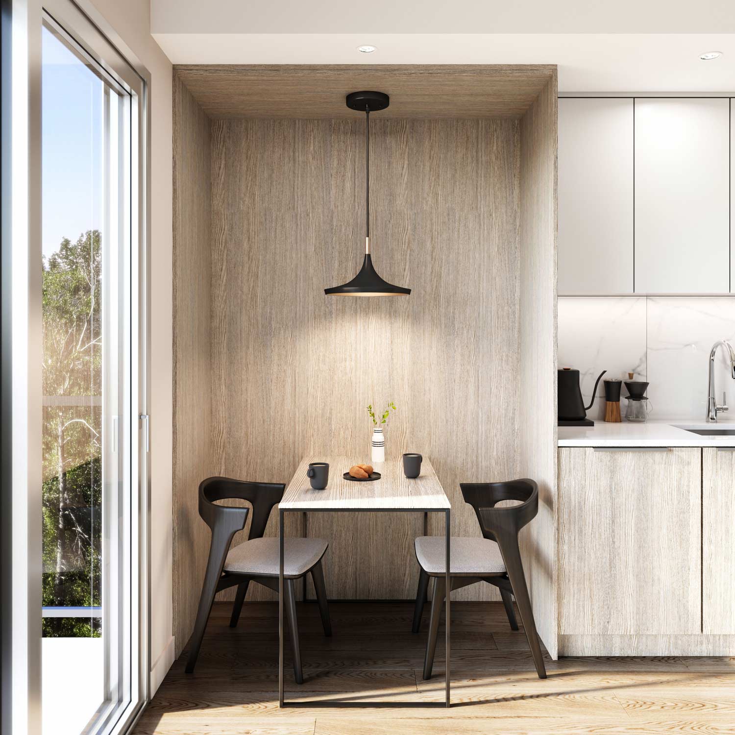 Sitka House – Small wood-lined dining nook with a two-person table and pendant light, situated beside the kitchen and a balcony door.