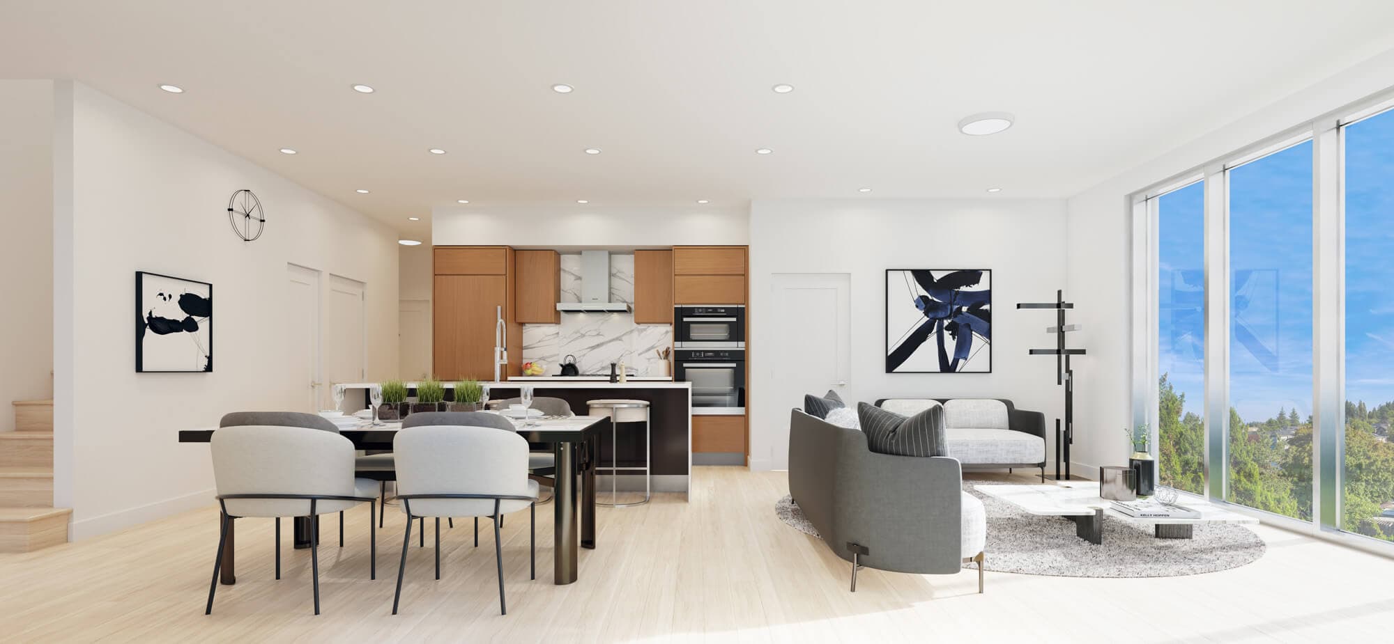 The Arbutus – Open-concept living, dining, and kitchen area with light wood cabinetry, marble backsplash, a dark dining table, and grey sofas near floor-to-ceiling windows.