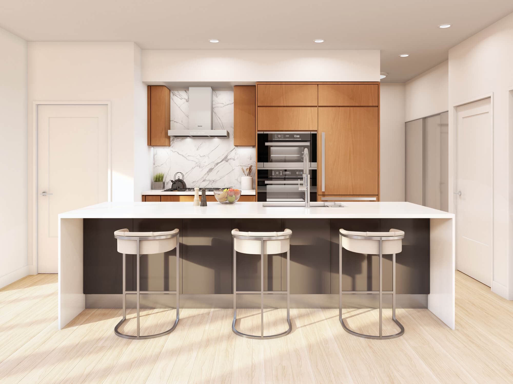 The Arbutus – Kitchen with light wood cabinetry, a marble backsplash and hood, built-in double ovens, and a white island with three cream bar stools.