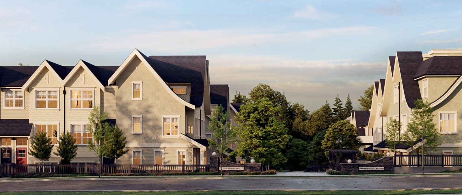 The Robinsons Parkside Collection – Twilight street-level view of cream and grey shingle-style townhomes with steep gabled rooflines, entry monument signs reading 'The Robinsons' and 'Parkside Collection', and mature trees along the sidewalk.