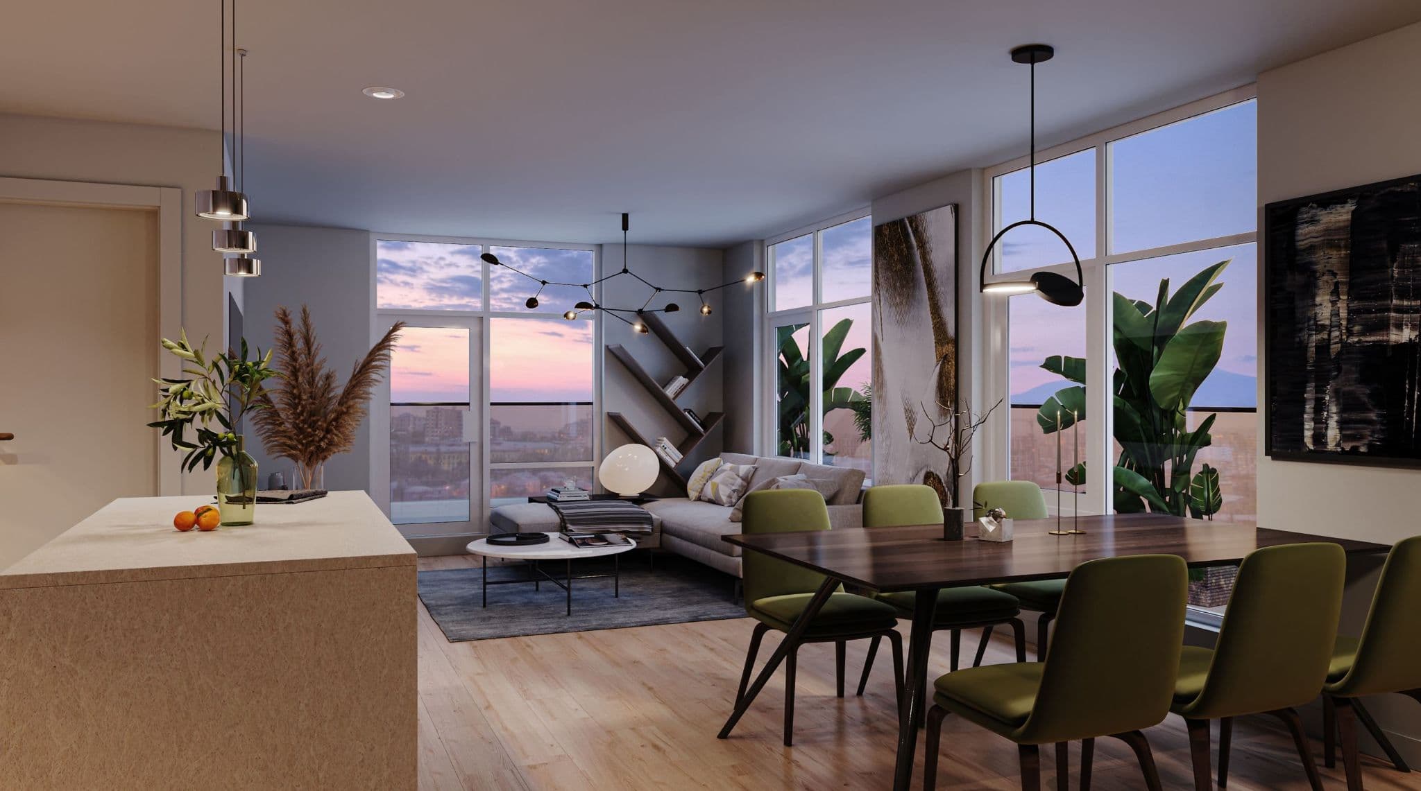 Luxio on the Park – An open-concept condo living and dining space features a dark wood dining table with olive green chairs, a modern light-colored sofa sectional, and a kitchen island in the foreground. Floor-to-ceiling windows display a vibrant dusk sky in shades of pink and blue over a city skyline.