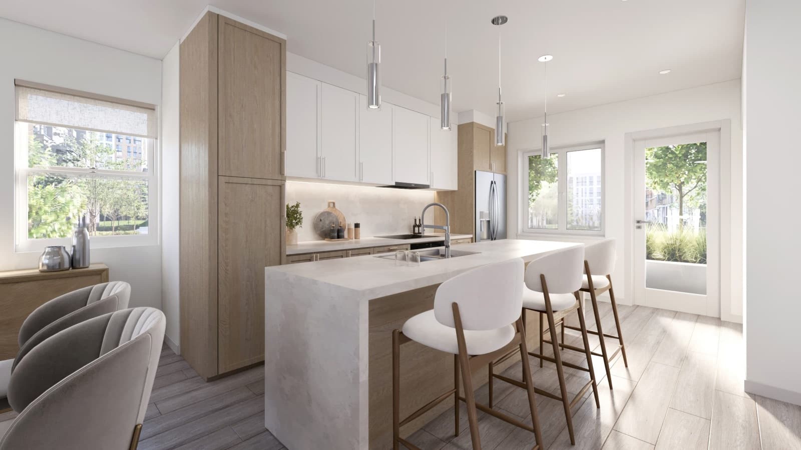 Compass Cohousing – Kitchen with a waterfall-edge island, wood and white cabinetry, pendant lighting, bar stools, and a glass door opening to a patio.