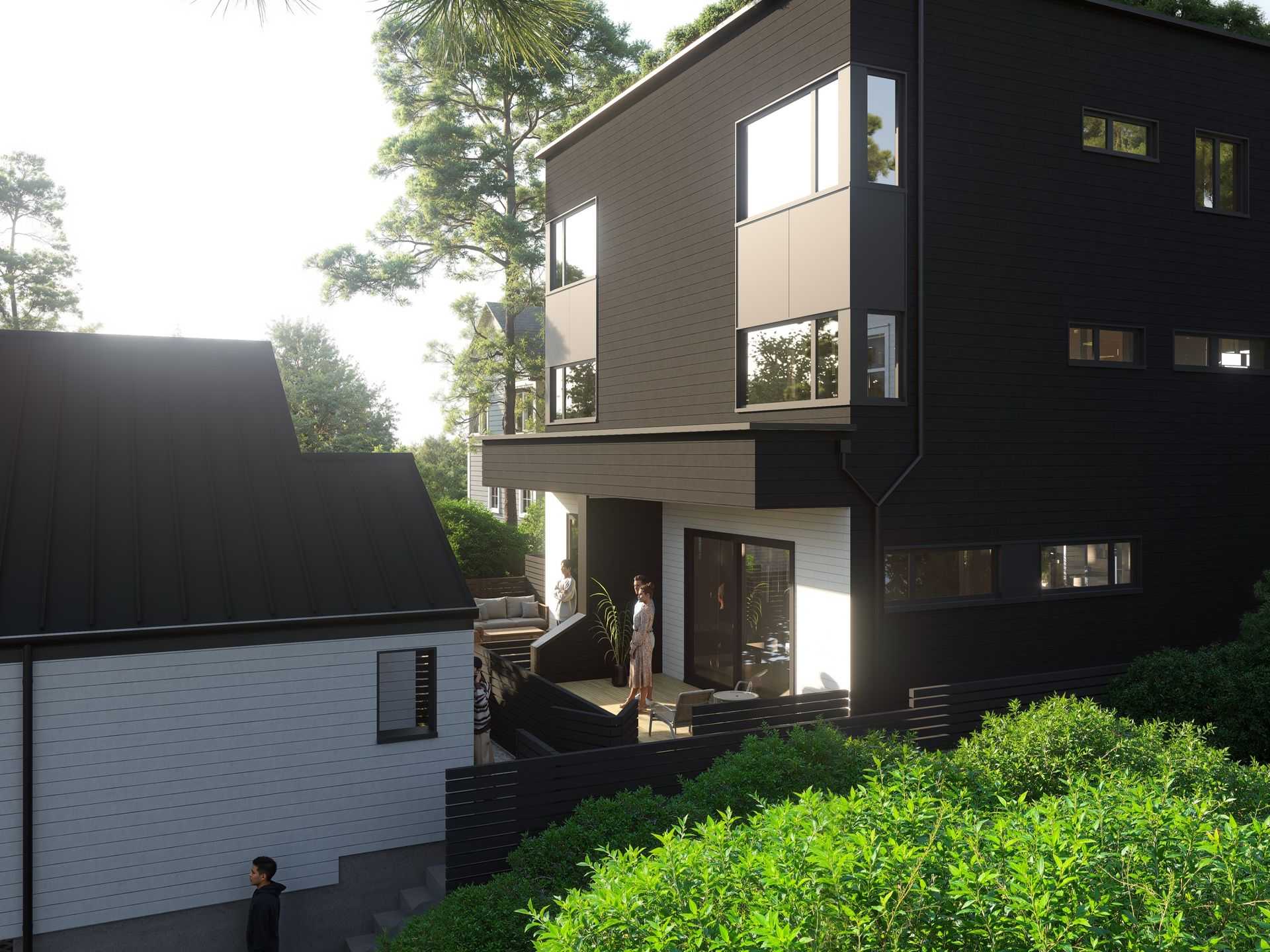 The Park Residences – A contemporary multi-story home featuring dark charcoal siding and large geometric corner windows, paired with an adjacent light gray structure. Figures are gathered on a tiered wooden back patio and stairs nestled into lush green foliage and mature pine trees in bright daylight.