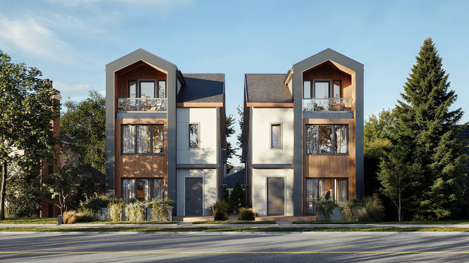 Solin – A ground-level view of two modern, three-story residential buildings featuring gabled roofs, light grey panels, and warm vertical wood siding on sunny clear daytime. The structures are surrounded by lush green trees and manicured planters, situated across a paved street.