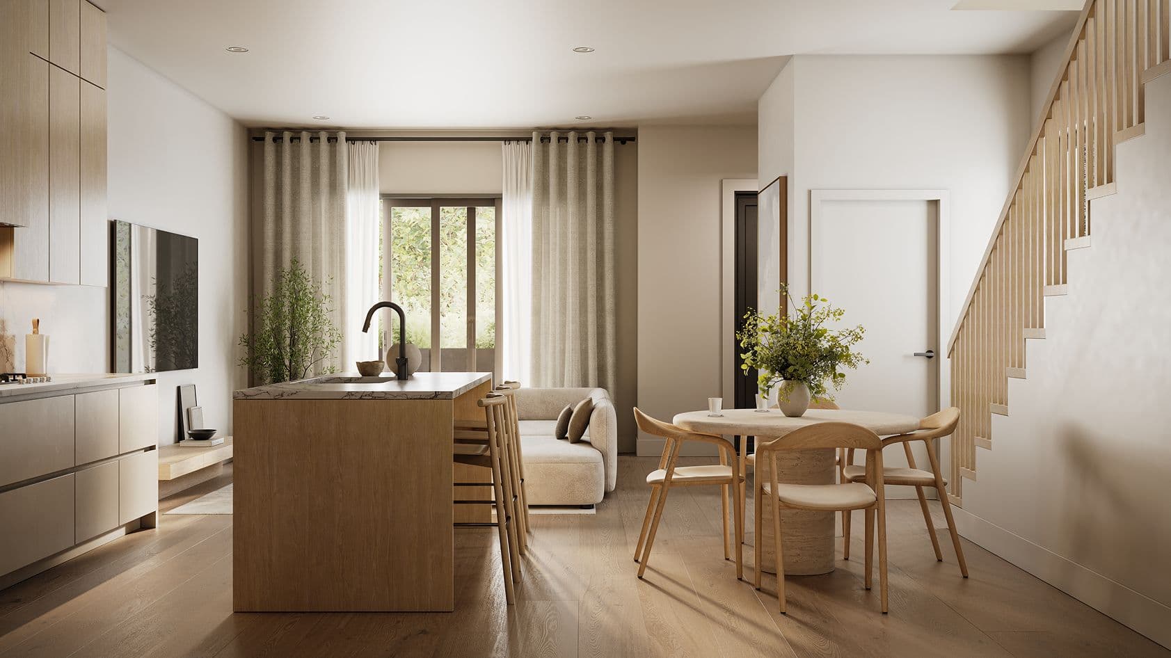 Solin – A bright, open-concept townhouse interior featuring light wood flooring, a kitchen island with bar seating, and a small round dining table. Neutral beige tones, warm sunlight, modern cabinetry, and an adjacent staircase create a serene, contemporary home atmosphere.
