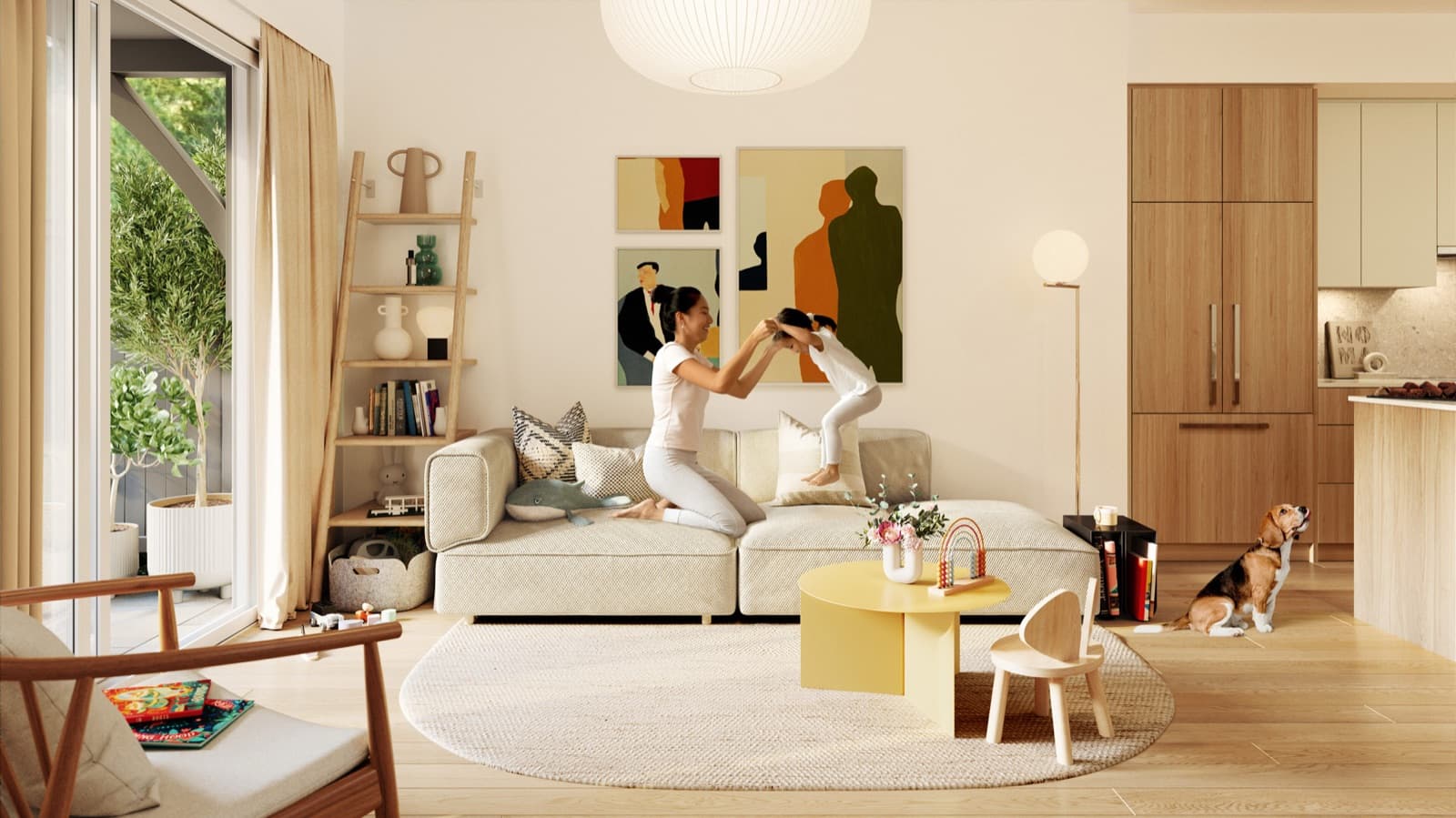 Towns at Lynn – Living room with a mother playing with a child on a beige sofa, a dog nearby, and an open kitchen with wood cabinetry in the background.