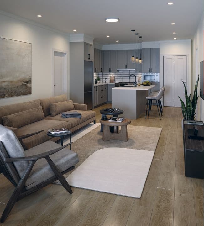 Chronicle – An open-concept living room and kitchen featuring light wood-look flooring, a beige sofa, and contemporary armchairs centered around wooden coffee tables. In the background, the kitchen includes gray shaker-style cabinetry, white subway tile backsplash, a central island with pendant lighting, and stainless steel appliances.
