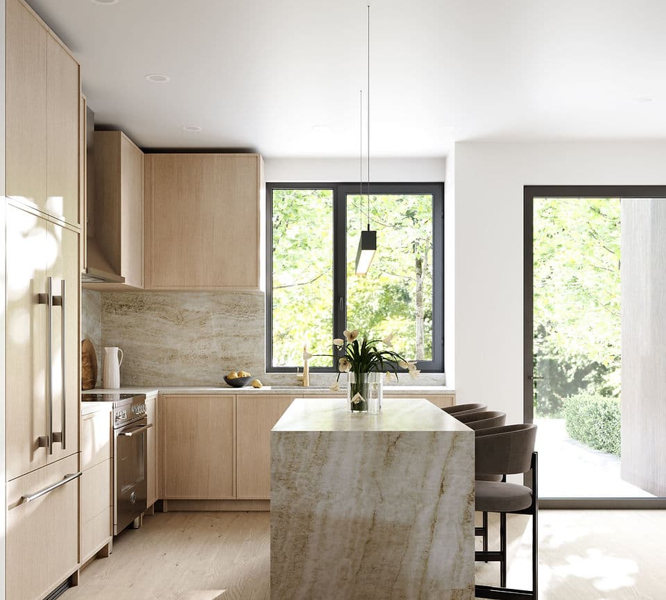 Park & Granville – A bright, modern kitchen features light wood flat-panel cabinetry and a dramatic waterfall island clad in veined marble-like stone with seating for three. Large black-framed windows and a glass door let in abundant daylight while framing views of lush green trees outside.