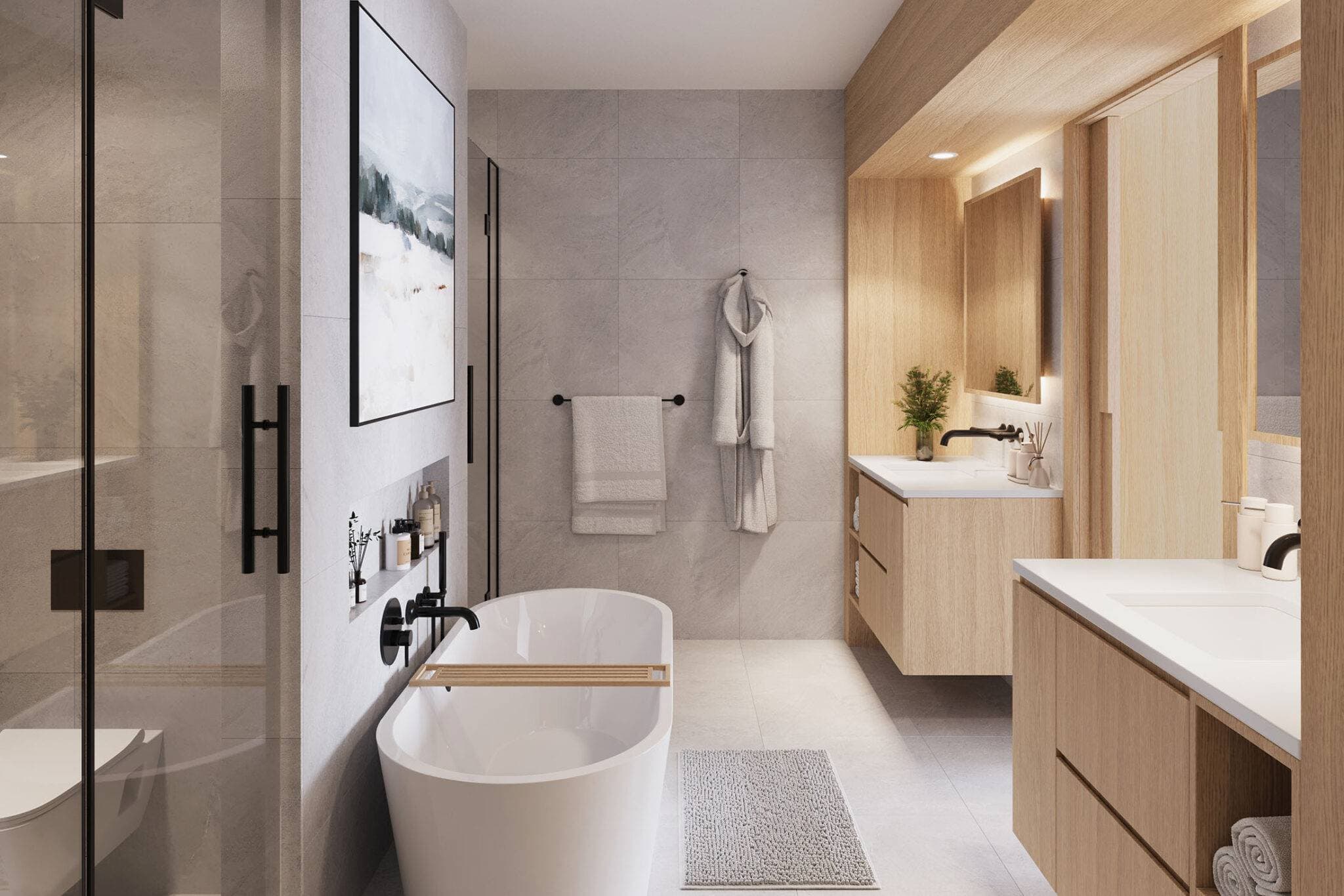 Obsidian on Tenth – A modern, spa-inspired bathroom featuring a freestanding white soaking tub with black matte fixtures, large-format grey stone wall tiles, and glass-enclosed shower. Floating light-wood vanities with white countertops and backlit mirrors add warmth to the bright, contemporary space.