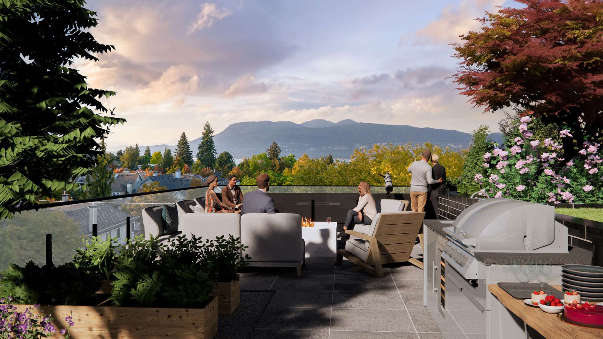 Obsidian on Tenth – A rooftop amenity terrace featuring an outdoor BBQ grill station, a fire pit, and comfortable lounge seating surrounded by lush planters. People socialize and enjoy expansive views of a forested neighborhood, distant water, and rolling mountains under a warm twilight sky.