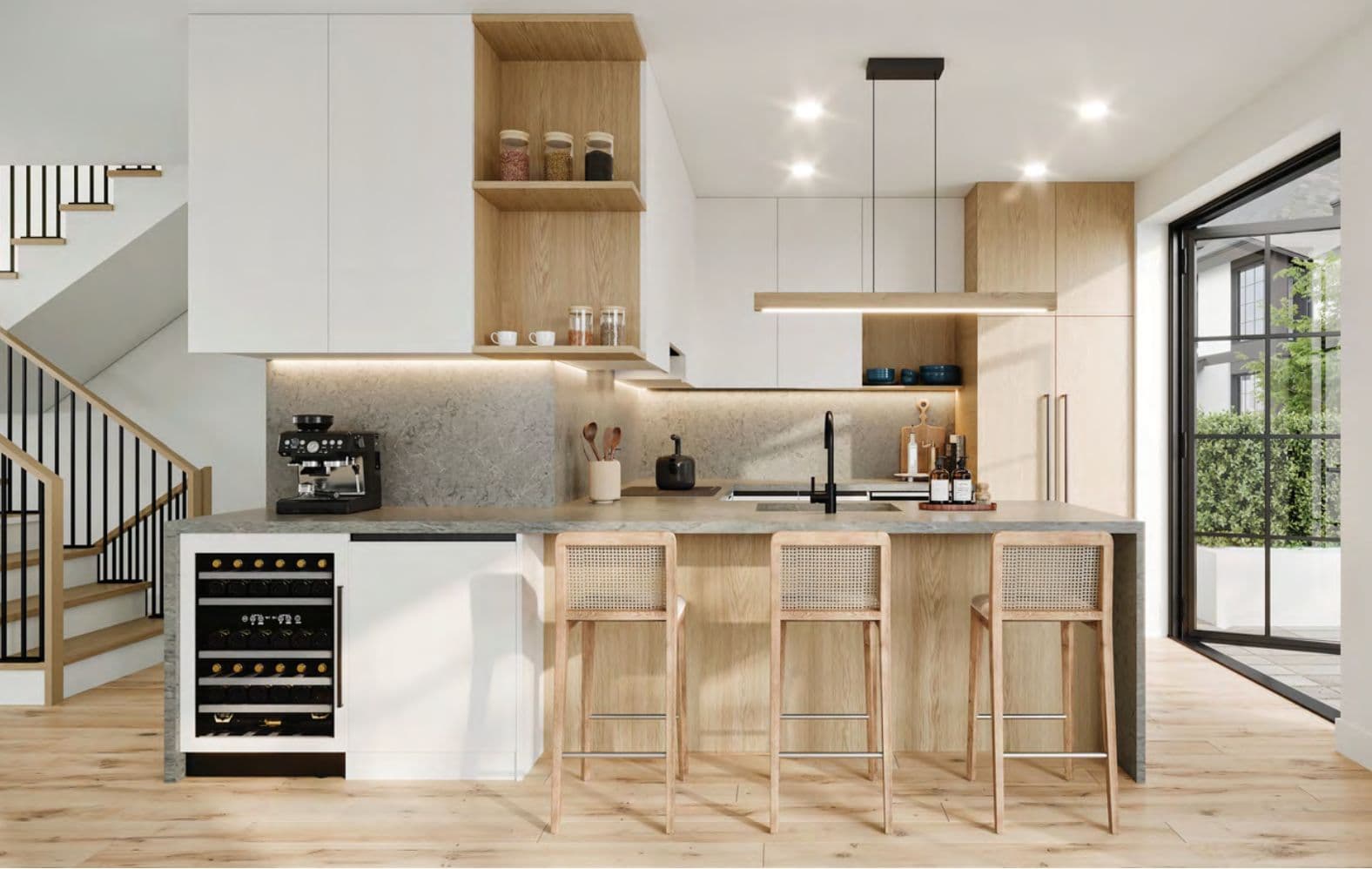 The Edgemont Collection – A kitchen with white and wood cabinetry, a built-in wine fridge, an espresso machine, pendant lighting, a staircase, and glass doors leading to a patio.