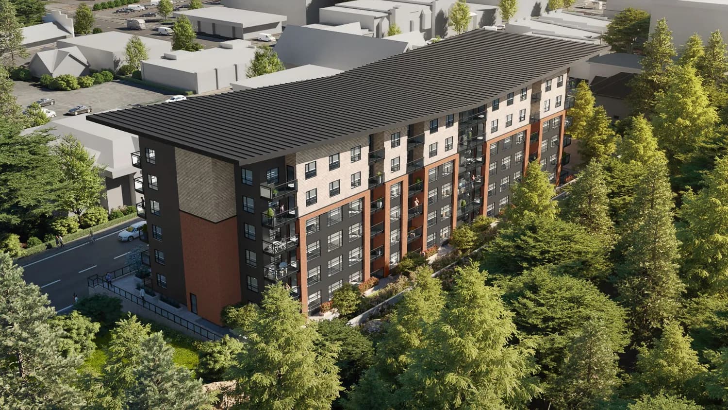 Skyside – Aerial drone photo of a multi-story apartment building with a dark shed roof and red brick and black paneled facade, surrounded by mature trees.
