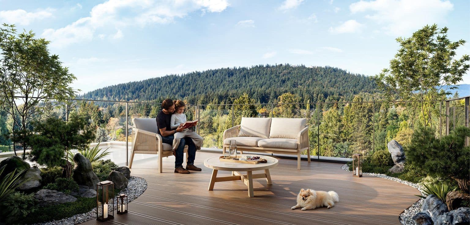 Satori – Furnished rooftop terrace with lounge seating, a coffee table, a couple reading together and a small dog, overlooking a forested hillside.