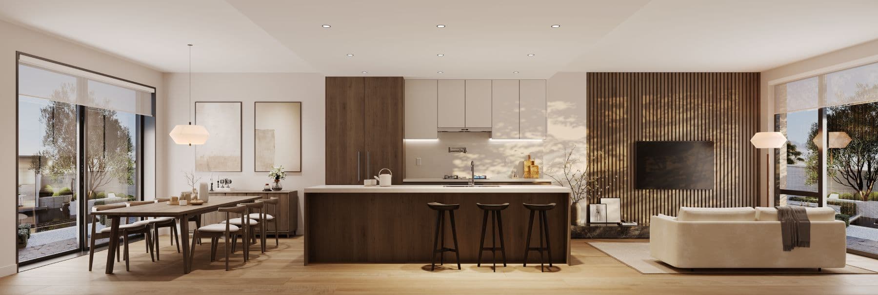 Satori – Wide view of an open-plan dining table, kitchen island with bar stools, and living room with sofa and wall-mounted TV on a wood slat accent wall.