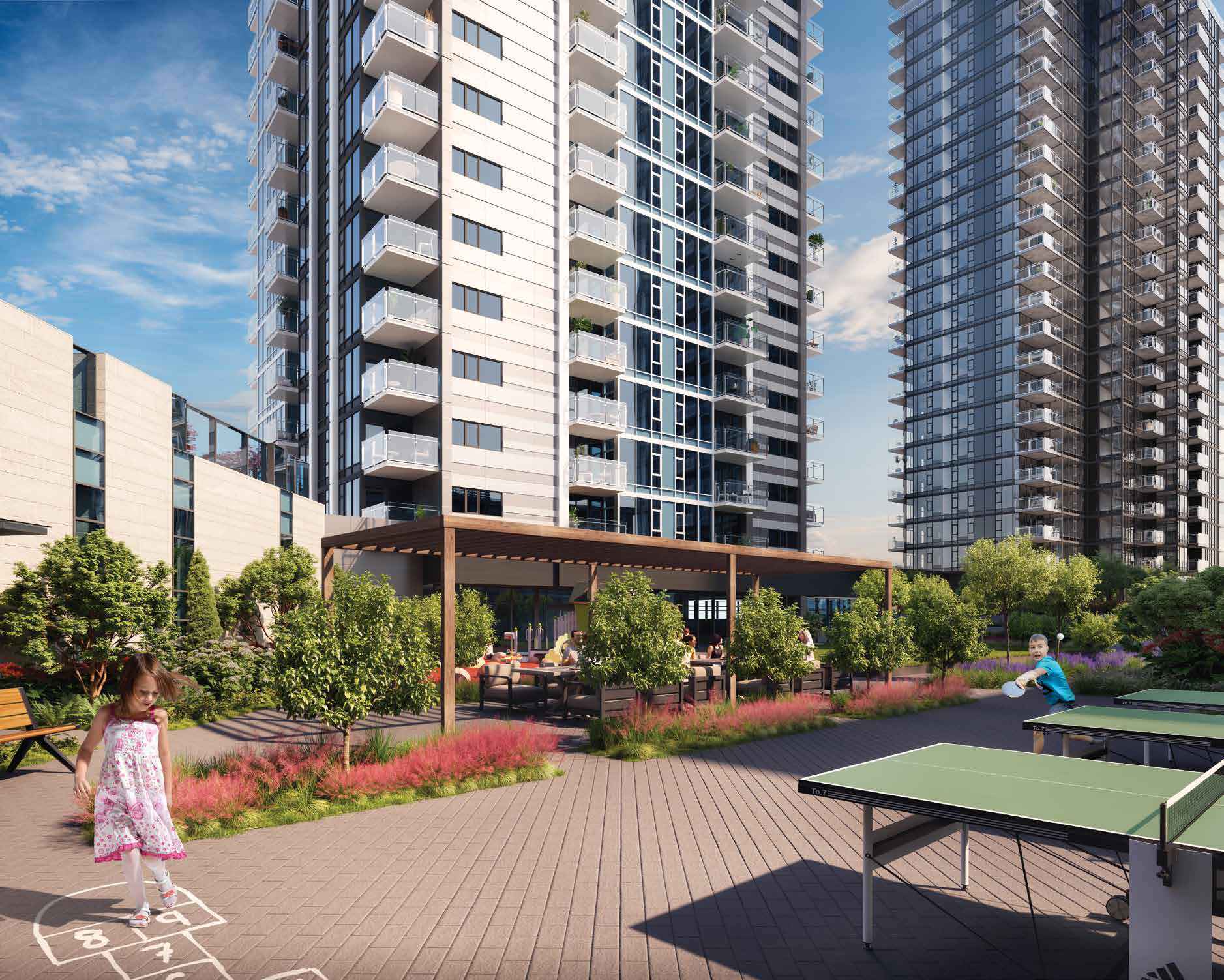 Burquitlam Park District – Outdoor courtyard with a wood pergola over lounge seating, planters with ornamental grasses, and children playing hopscotch and table tennis between the towers.